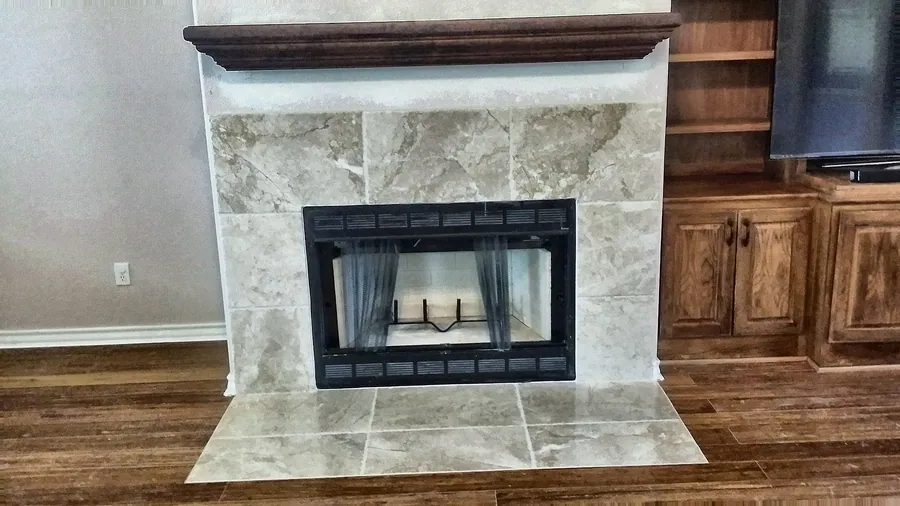 Stone-clad fireplace with sleek dark firebox.