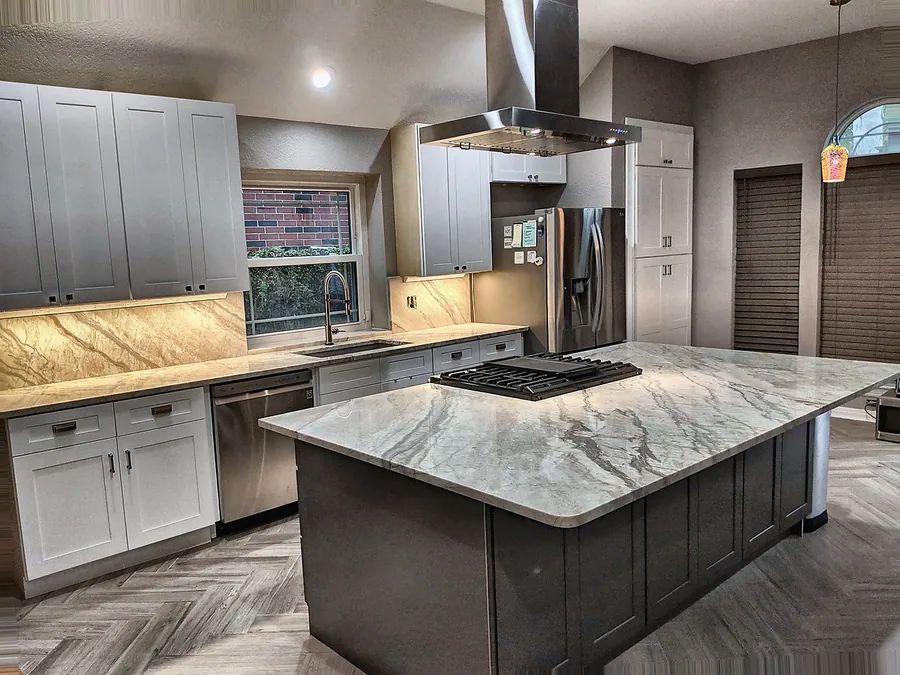 An open kitchen centered on a substantial stone-look island.