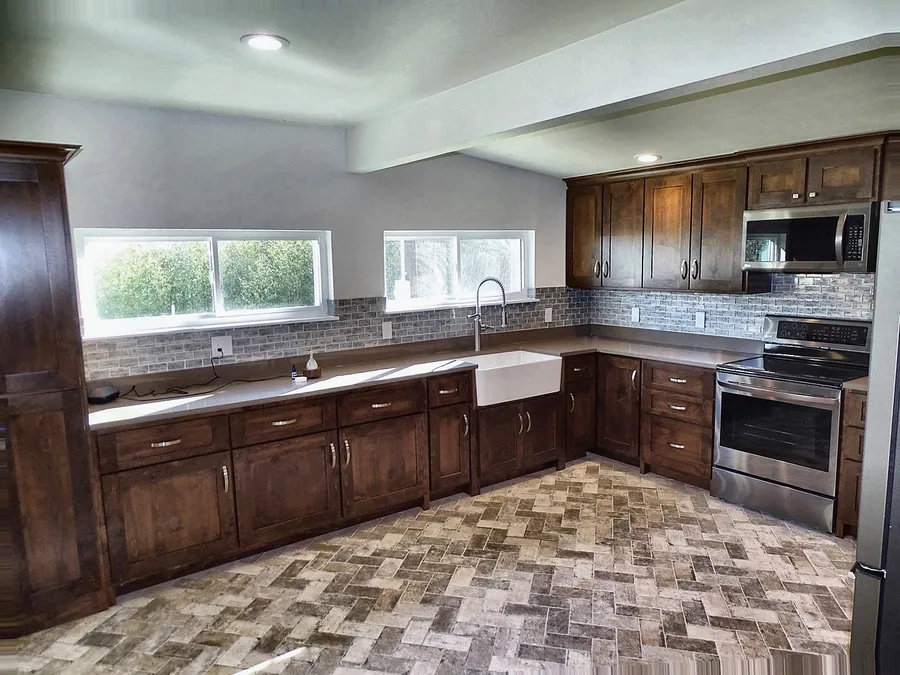 A traditional kitchen with stone-patterned tile flooring.