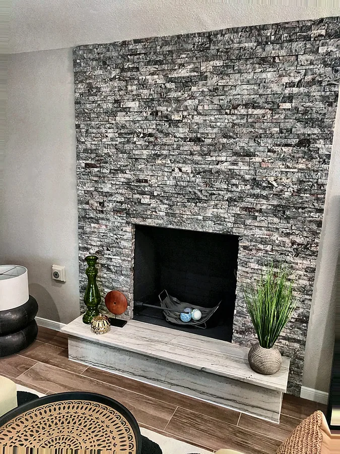 Vertical stone texture around a contemporary fireplace.