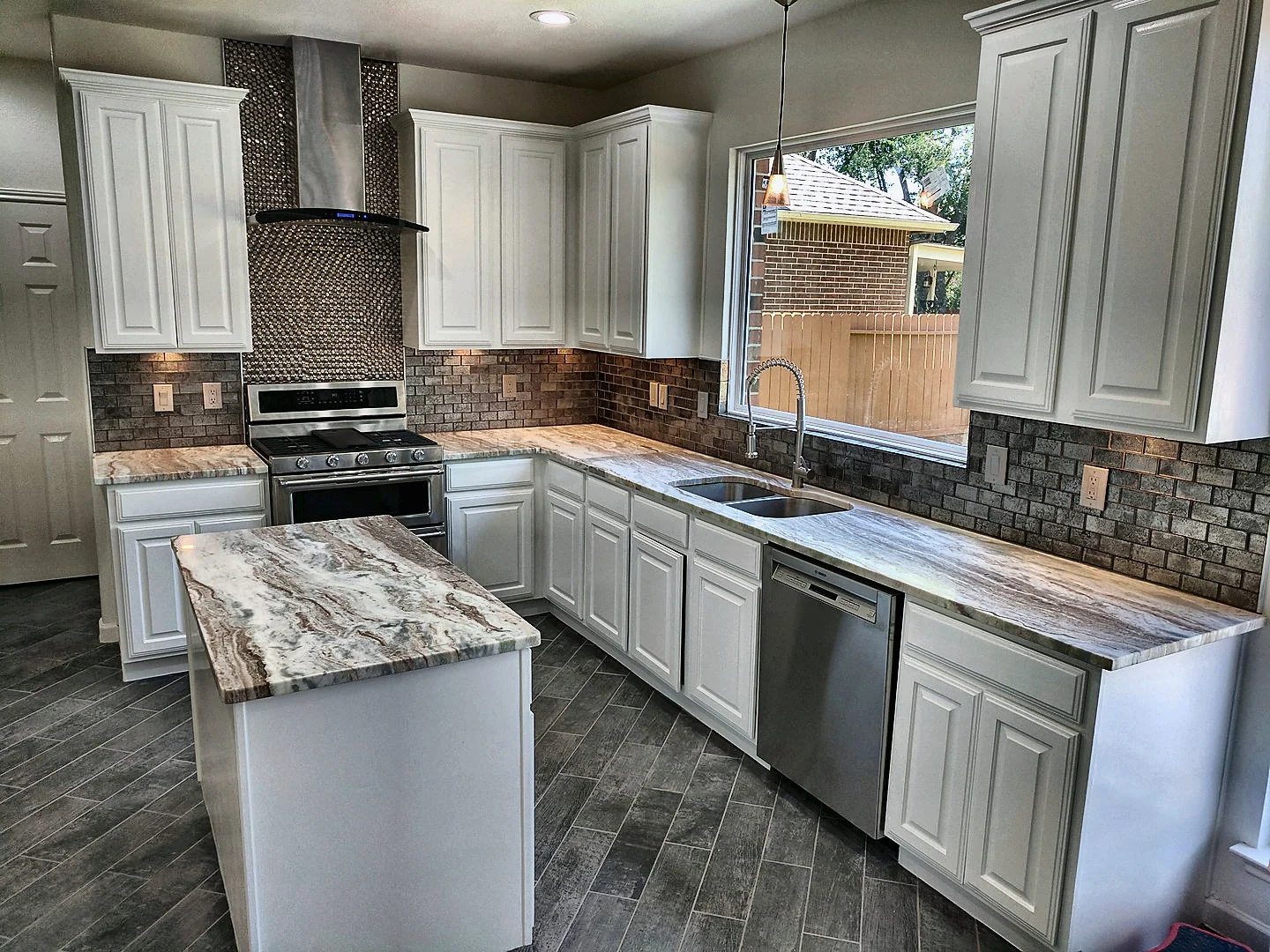 Bright white Zendo kitchen with island and refined backsplash