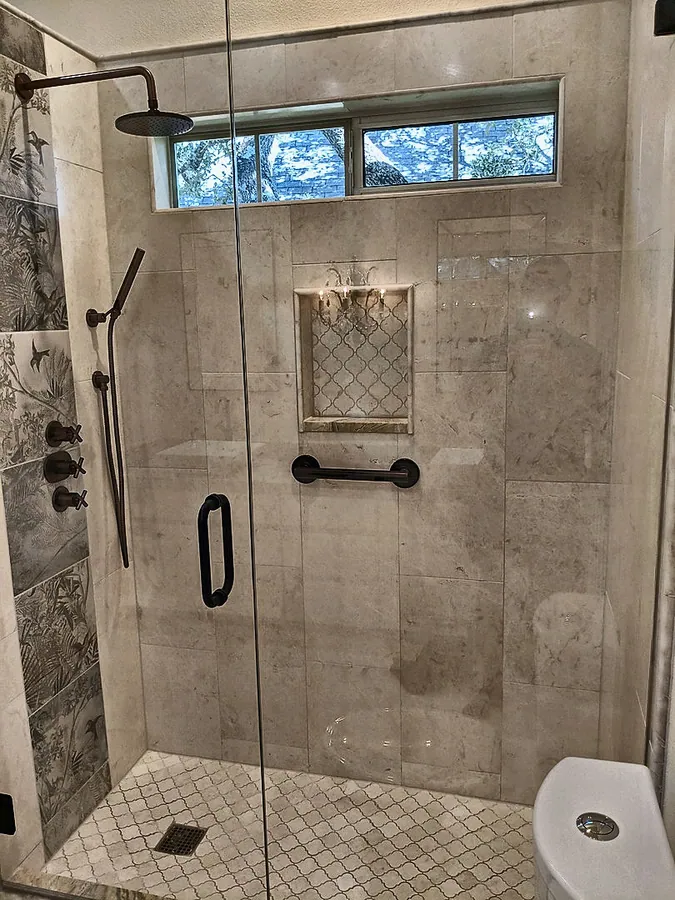 An inviting walk-in shower with a glass enclosure.