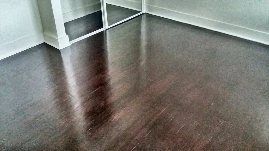 Deep wood-tone floor planks in a bright interior.