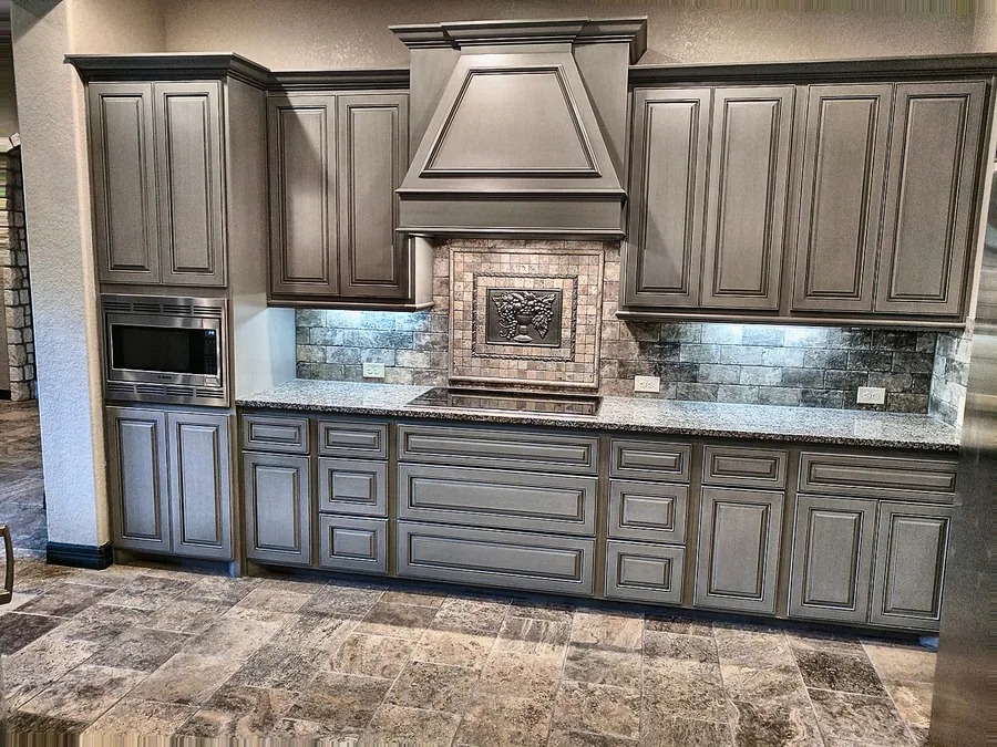 A custom-look kitchen wall with detailed cabinetry and backsplash.