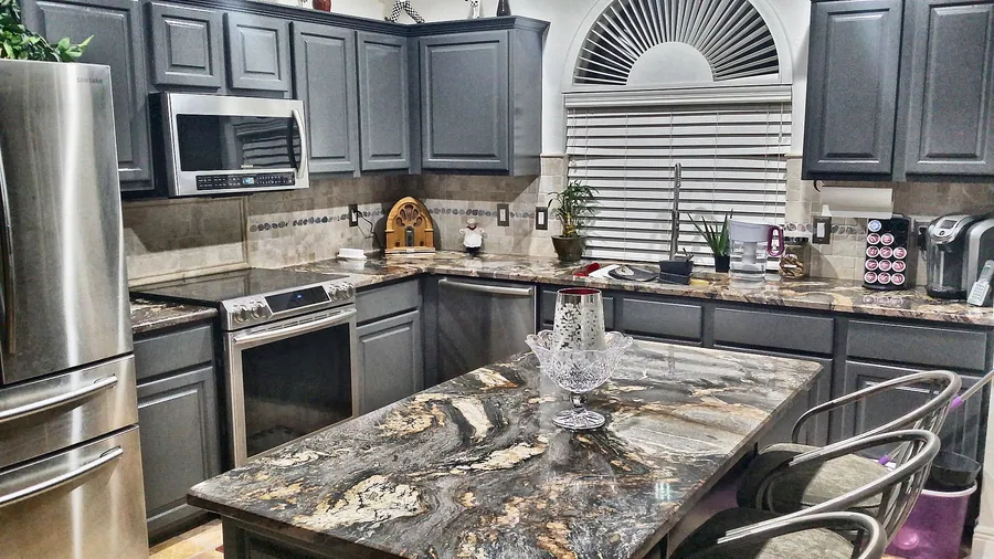 A dramatic countertop paired with deep-toned cabinetry.