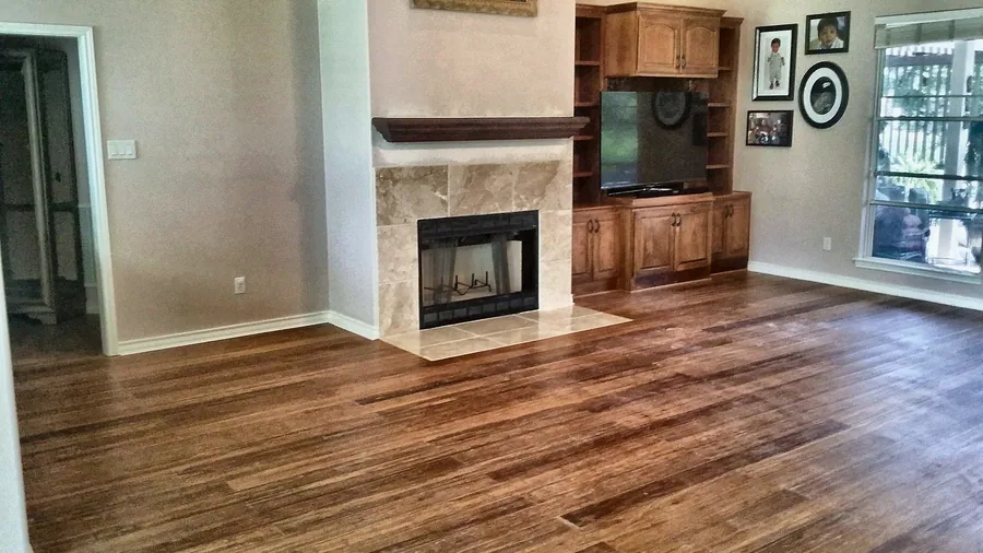 Continuous wood flooring and a stone-faced fireplace.