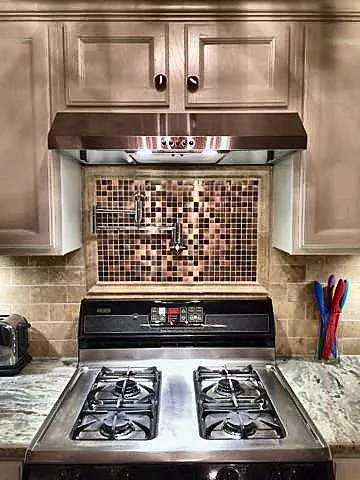 Decorative tile accent behind the cooking area.